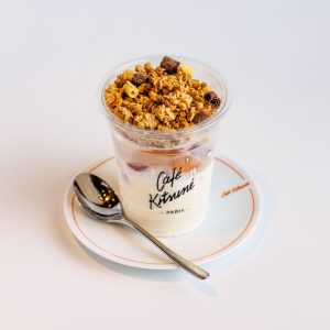 Menu Delicious granola and yogurt served in a branded Café Kitsuné cup.